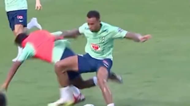 Endrick pictured falling to the ground following a strong tackle by defender Gabriel during a Brazil training session in November 2023